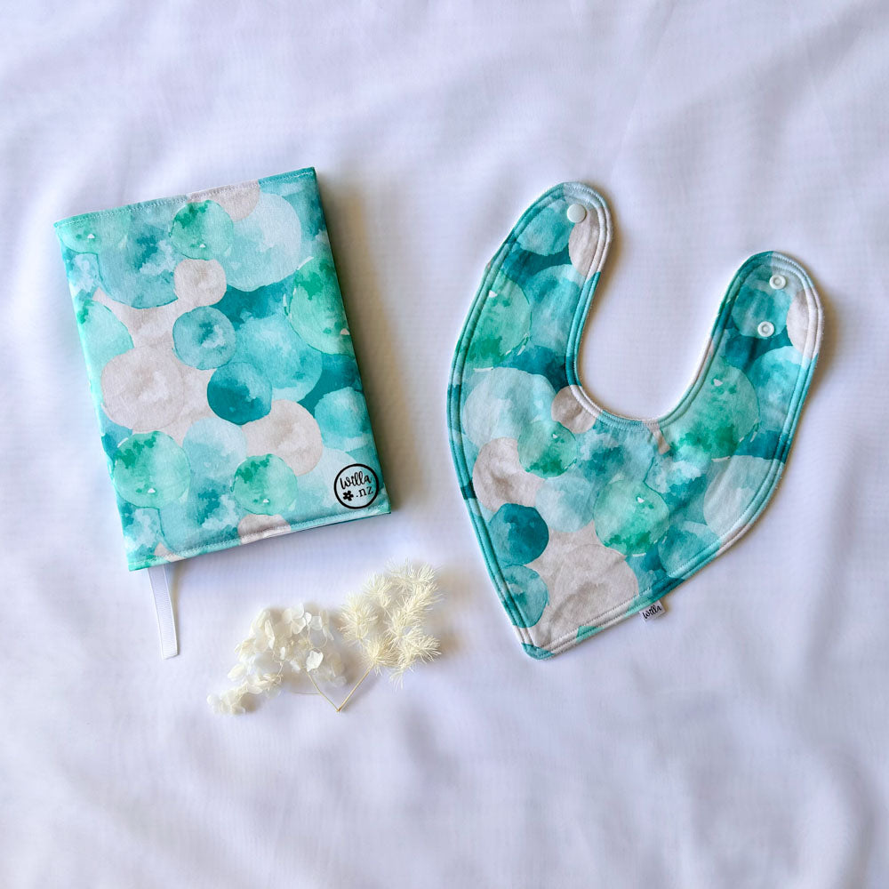 Willa Well Child/Plunket book cover and bib with green, blue and white bubble print
