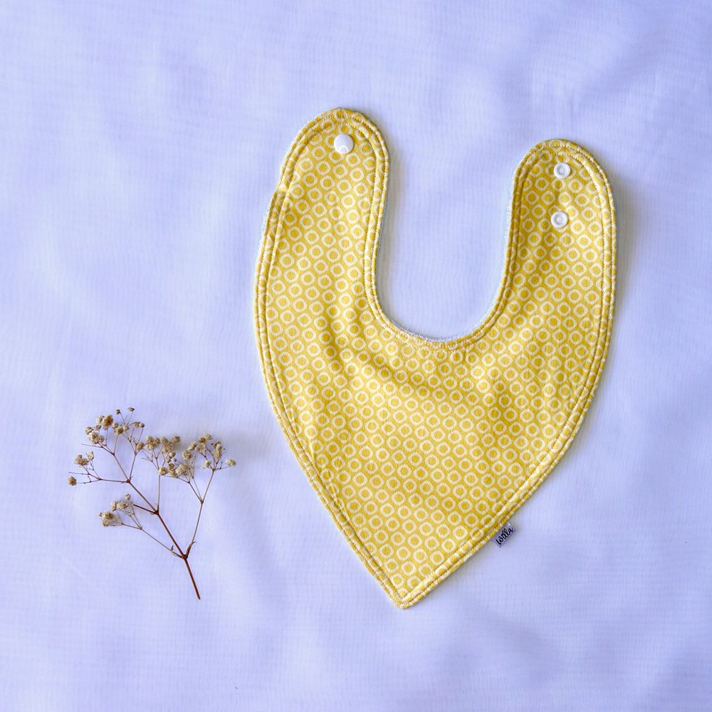 Willa bib with yellow background and white circles